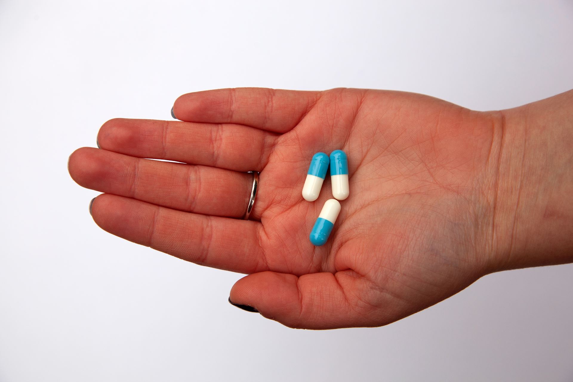 a person holding antibiotics in their hand