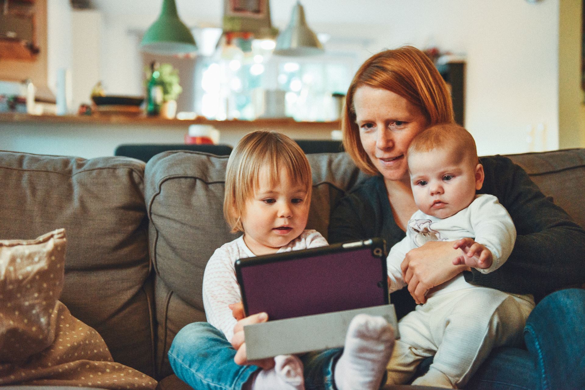 an adult with a young child and a baby